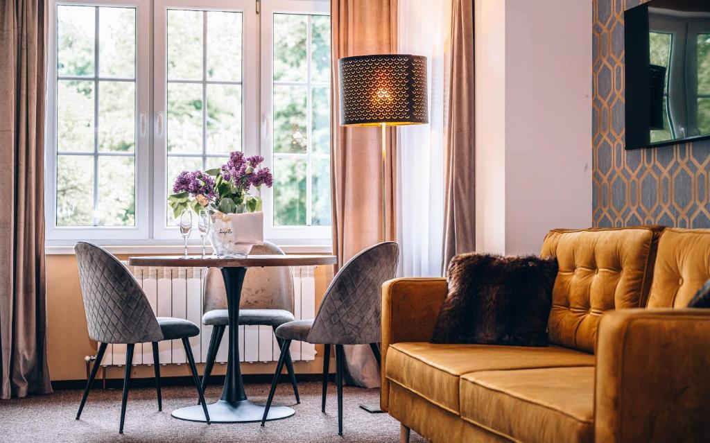 a living room with a couch and a table at Willa Skalniak in Lądek-Zdrój