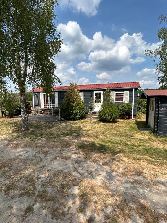 a house with a yard in front of it at Slapen op De Bult Green 2 persons in De Bult