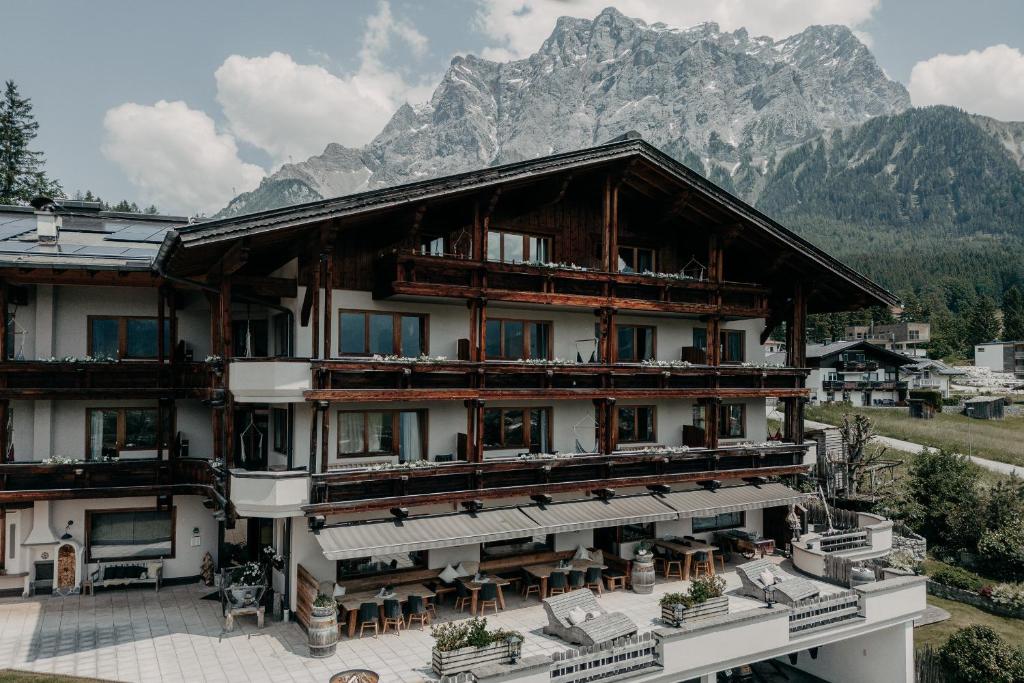 um grande edifício com uma montanha ao fundo em Alpenappartements Cristall em Ehrwald