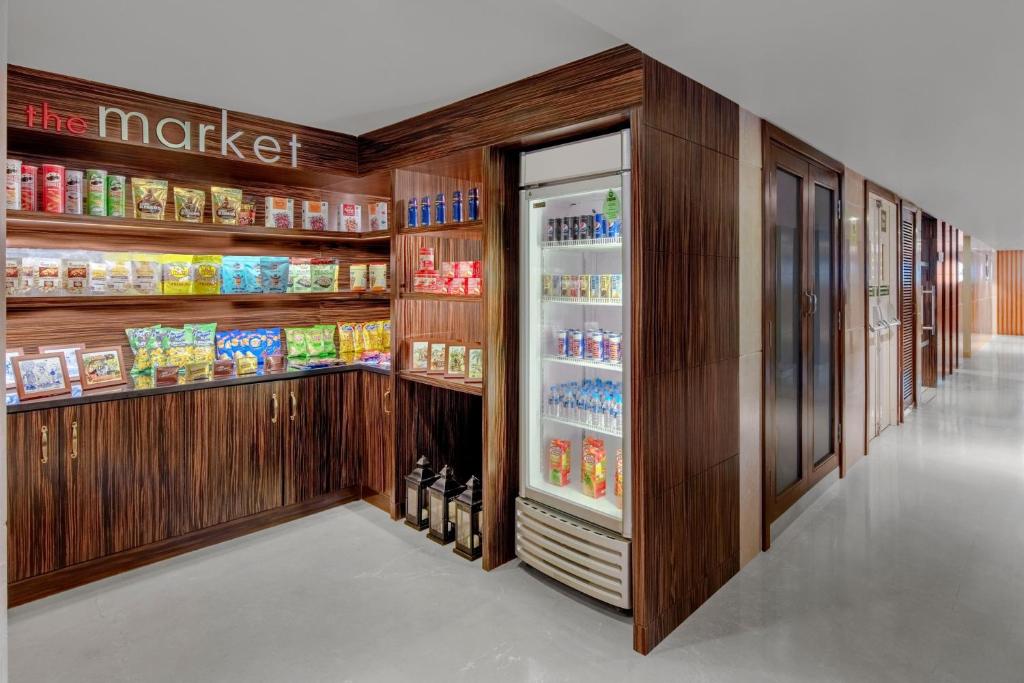 a grocery store aisle with an open refrigerator at Fairfield by Marriott Goa Calangute in Calangute