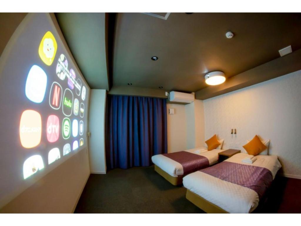 a hotel room with two beds and a large window at Hotel S-Presso West - Vacation STAY 9085 in Osaka