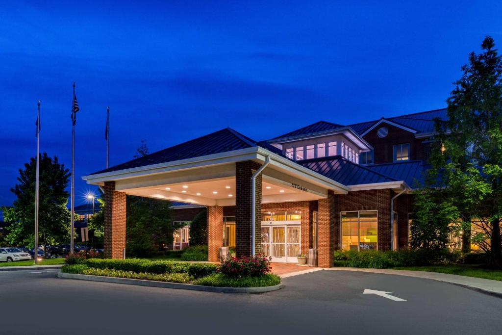 une grande maison avec une allée en face de celle-ci dans l'établissement Hilton Garden Inn Charlottesville, à Charlottesville