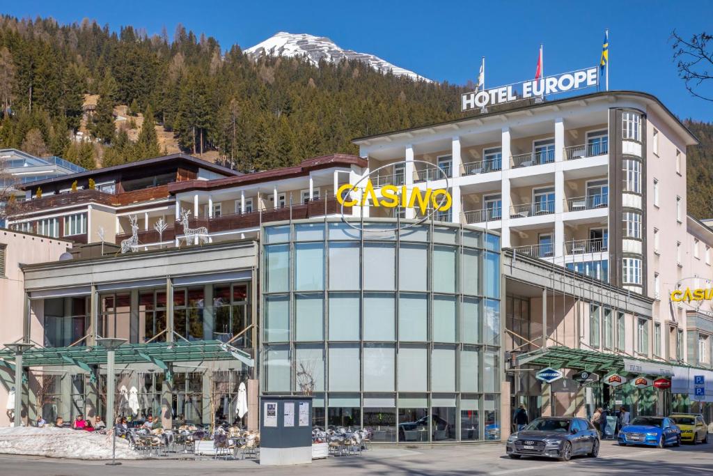 a building with a sign on top of it at Hotel Europe in Davos