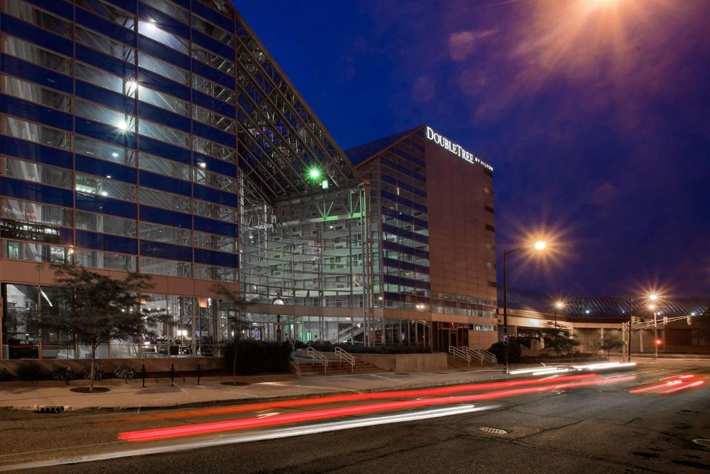 a tall building at night with cars driving past it at DoubleTree by Hilton Hotel South Bend in South Bend