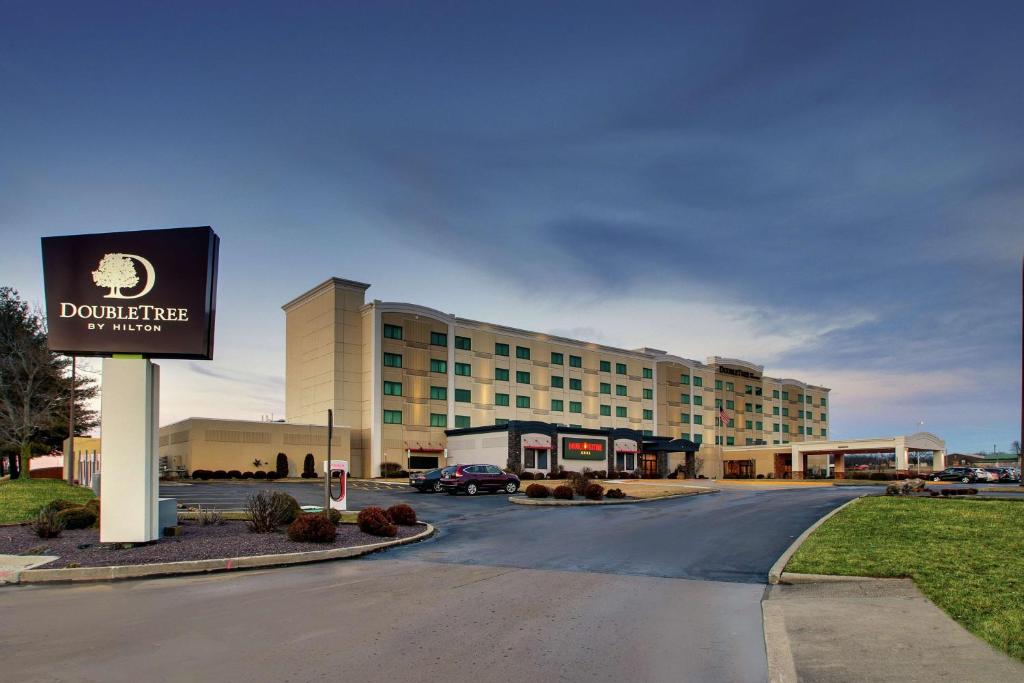 a building with a sign in front of a parking lot at Doubletree By Hilton Mt. Vernon in Mount Vernon