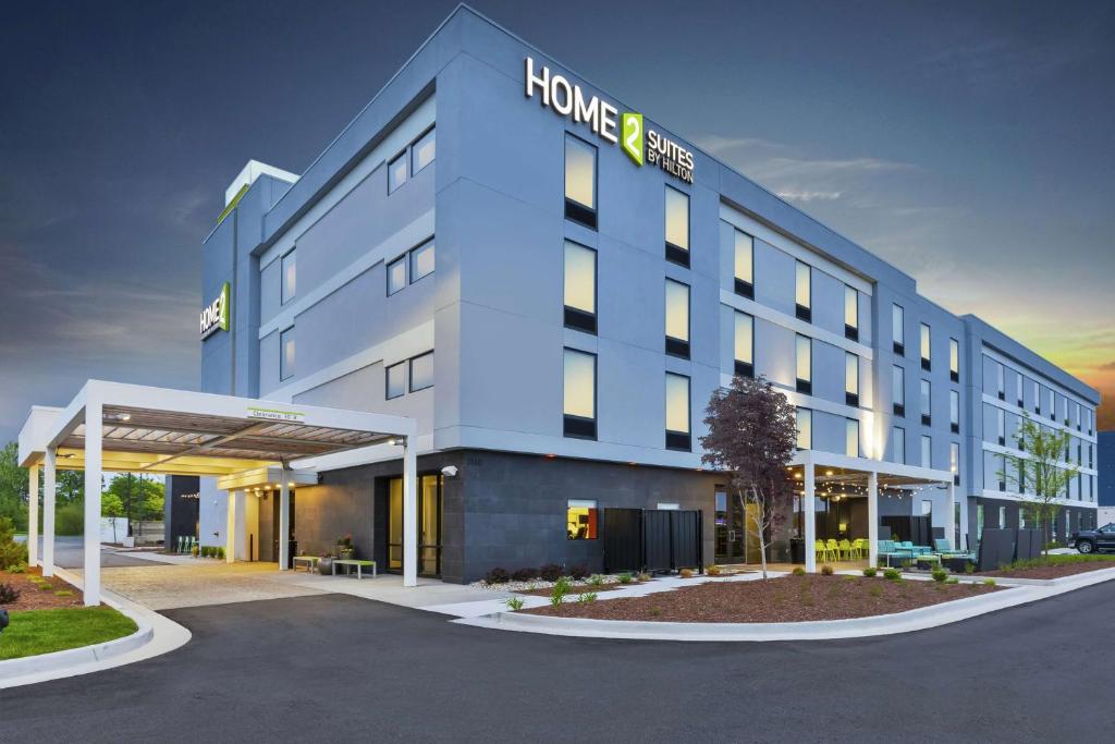 a large building with a home benefit sign on it at Home2 Suites By Hilton Holland in Holland