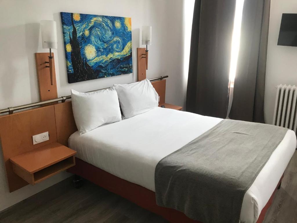 Postel nebo postele na pokoji v ubytování Hotel Morand