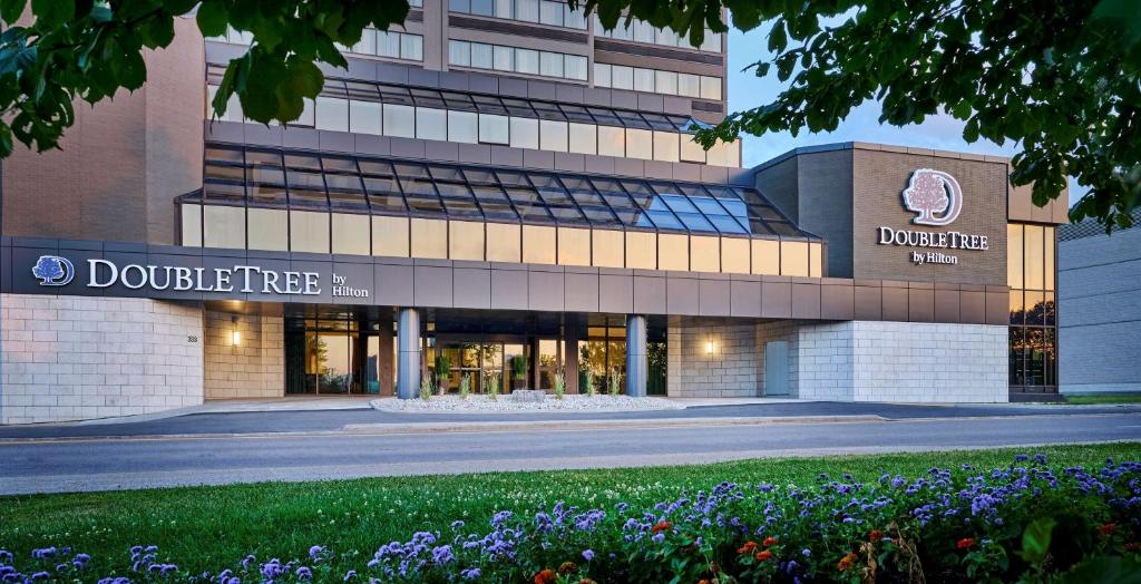 a building with flowers in front of it at DoubleTree by Hilton Windsor, ON in Windsor