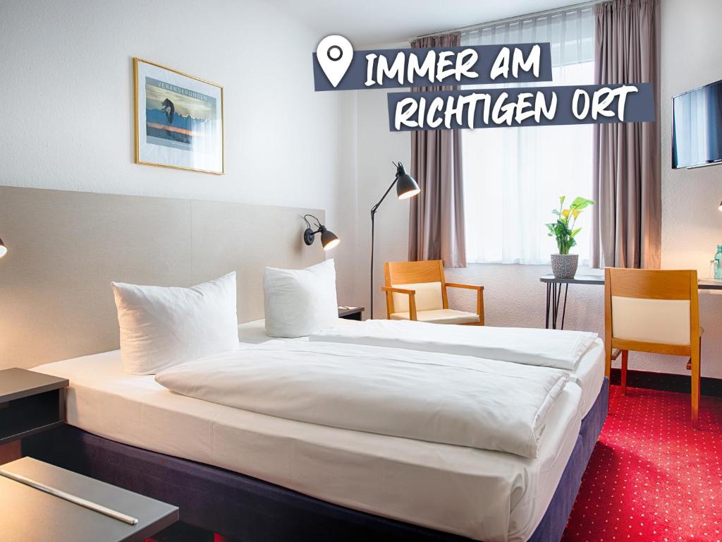 A bed or beds in a room at ACHAT Hotel Chemnitz