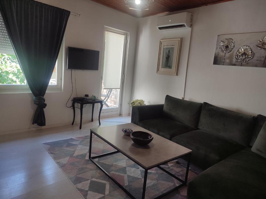 a living room with a couch and a coffee table at Apartment Mejdan in Mostar