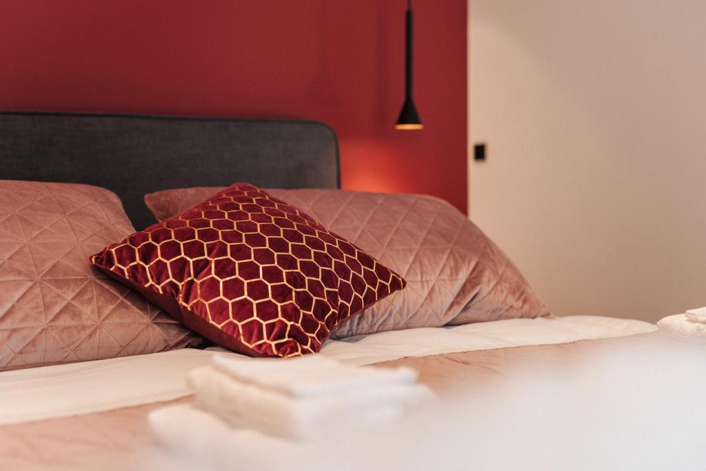 a bed with two pillows on top of it at BEE n BEE in Bruges