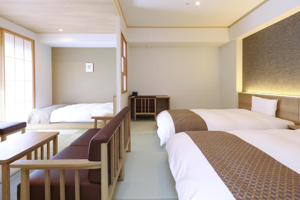 A bed or beds in a room at Dormy Inn Premium Ginza