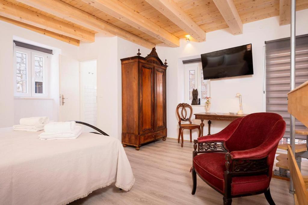 a bedroom with a bed and a chair and a desk at Golubica in Stari Grad