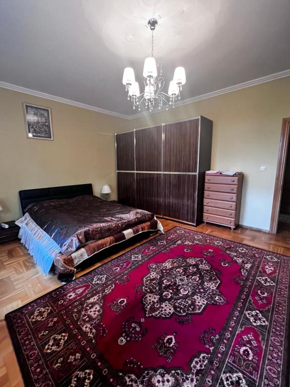 - une chambre avec un grand lit et un tapis rouge dans l'établissement Spacious rooms in peaceful Jelgava area, à Jelgava