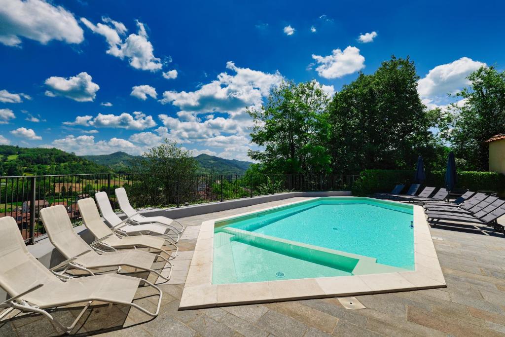 a swimming pool with lounge chairs and a swimming pool at Viavai in Casalborgone