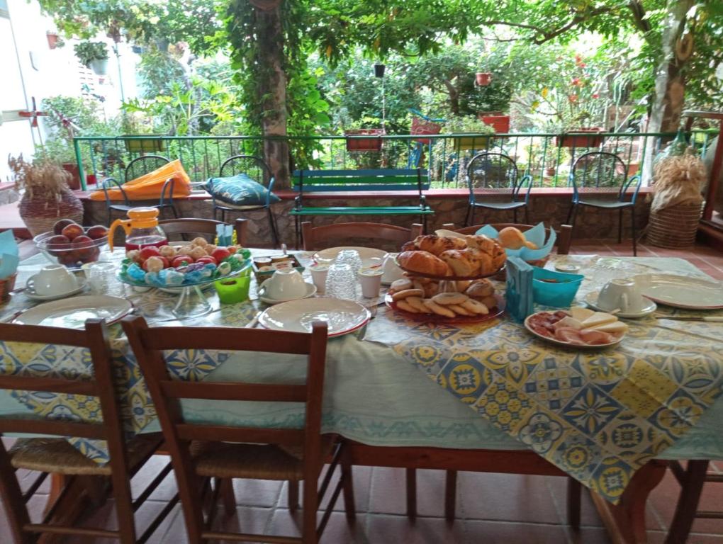 a table with a table cloth with food on it at Bed & Breakfast Paui in Càbras