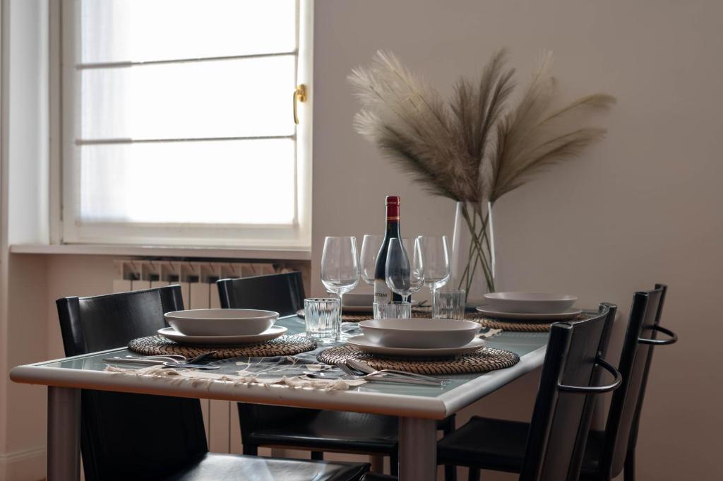 a dining room table with glasses and a bottle of wine at Domus Montebello in Rome