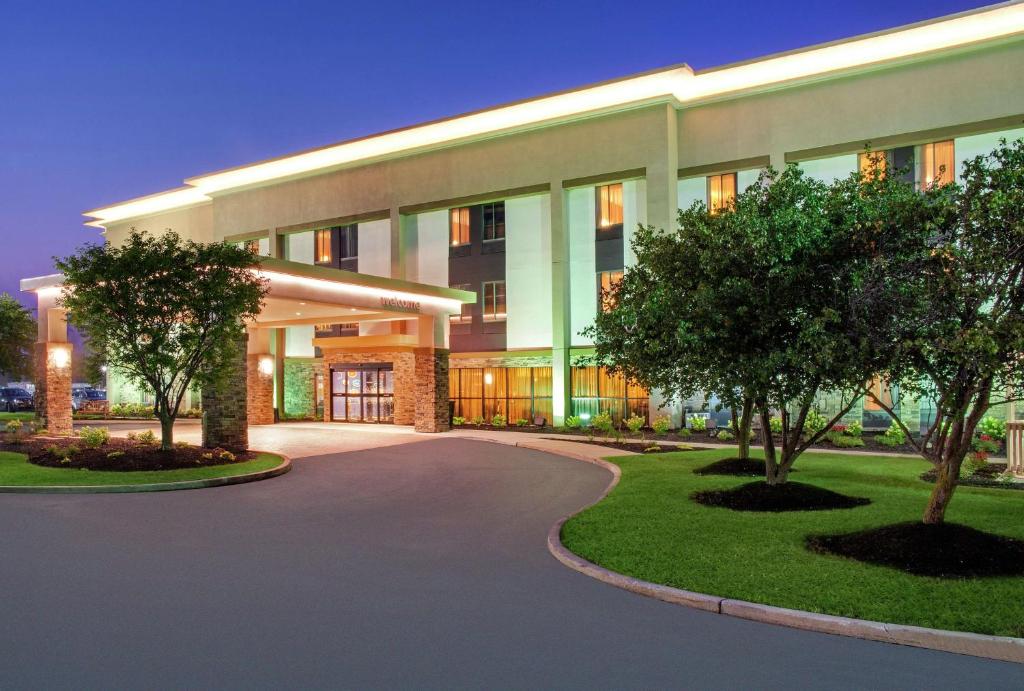 a large building with a driveway in front of it at Hampton Inn Merrillville in Merrillville