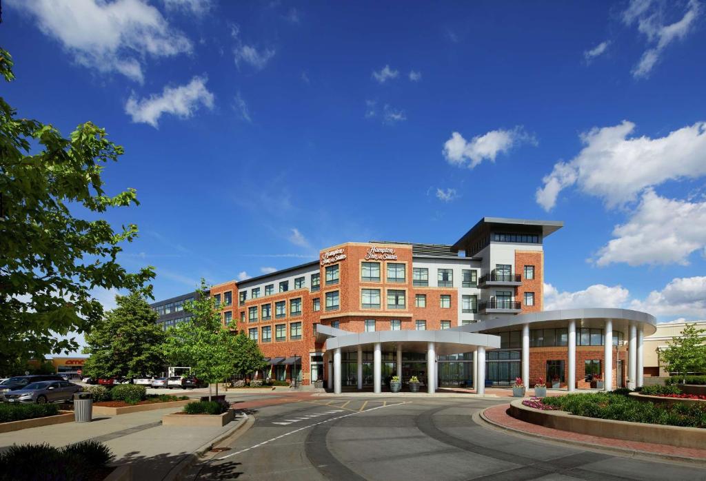 a large brick building with a street in front of it at Hampton Inn & Suites Mt. Prospect in Mount Prospect