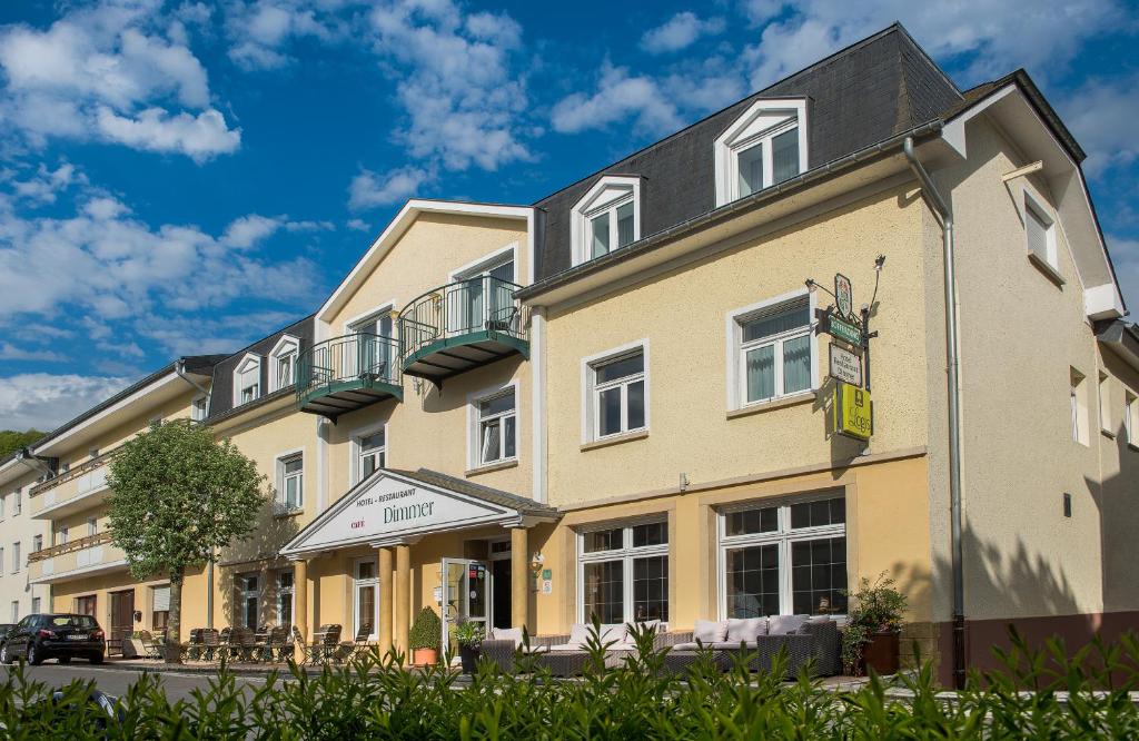 um grande edifício amarelo com um telhado preto em Logis Hotel-Restaurant Dimmer em Wallendorf pont