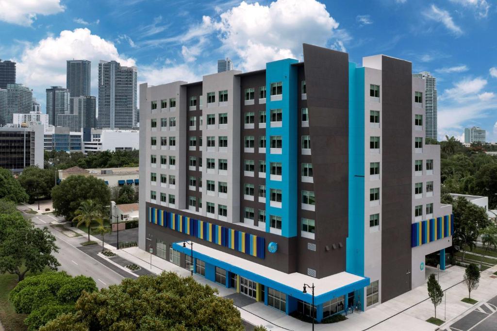 an apartment building in front of a city at Tru By Hilton Miami West Brickell in Miami