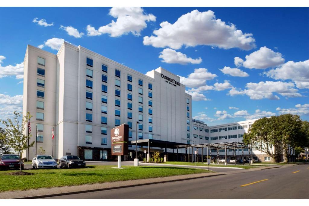 a white building with a sign in front of it at DoubleTree by Hilton Hotel Niagara Falls New York in Niagara Falls