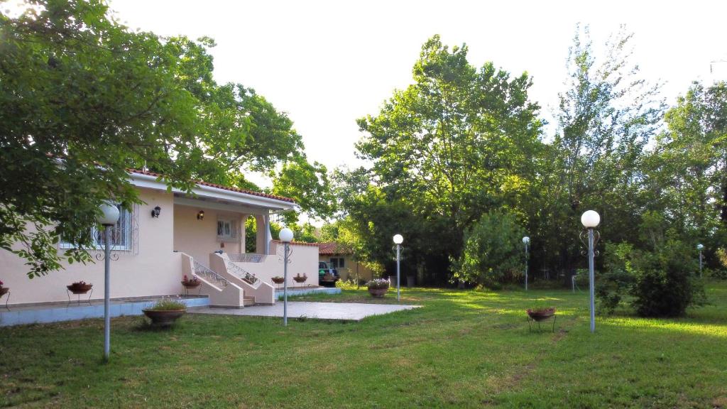 a house with a yard with lights in the grass at Villa Vivere in Corfu Town