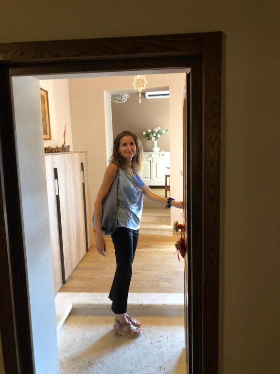 a woman standing in the doorway of a room at Neoclassico by Tiziana Monaldi in Pitigliano