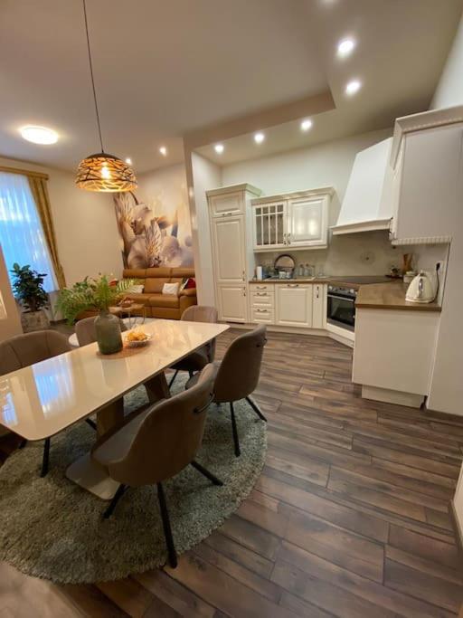 a kitchen and dining room with a table and chairs at Robert's Apartment in Celje