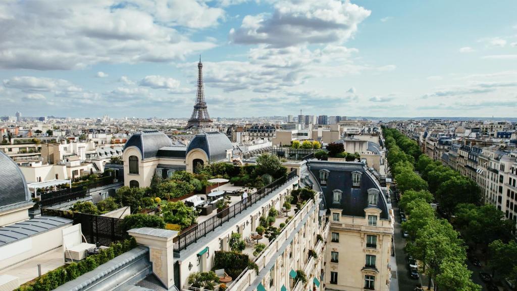 a view of the city of paris with the eiffel tower at The Peninsula Paris in Paris