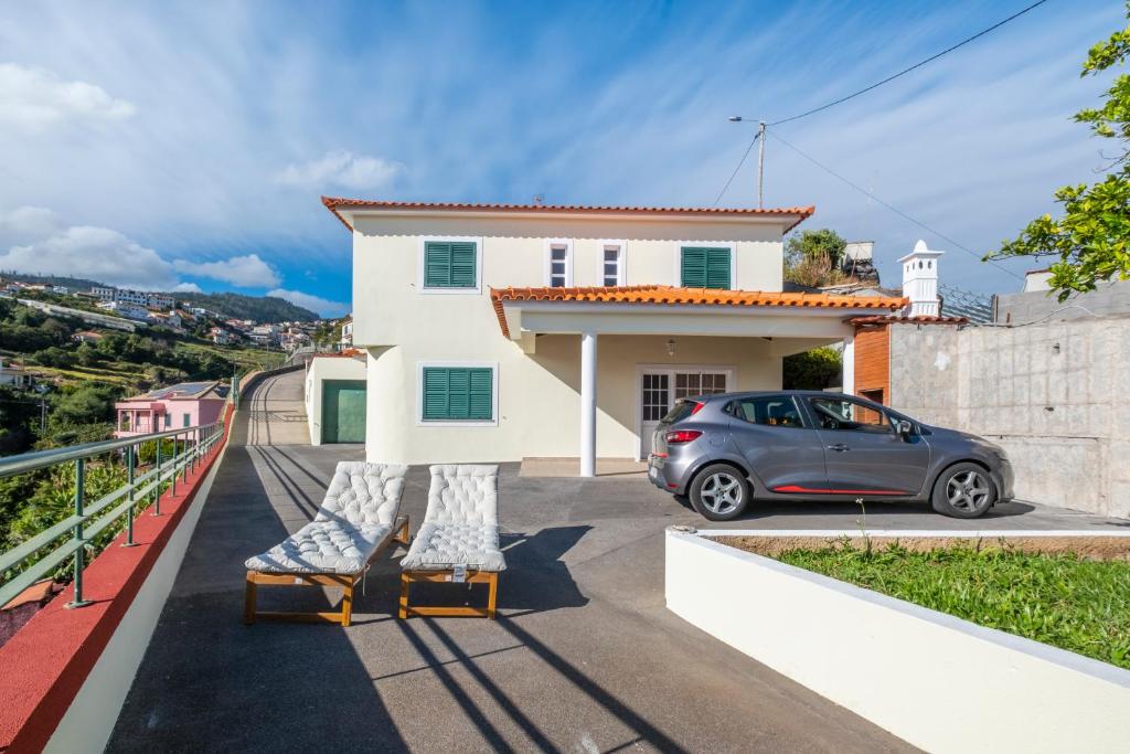 a house with a car parked in front of it at Casa Vista Mar by GALMI in Calheta