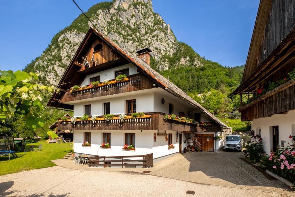 een gebouw met een balkon en een berg bij Turistična kmetija Pri Andreju in Bohinj