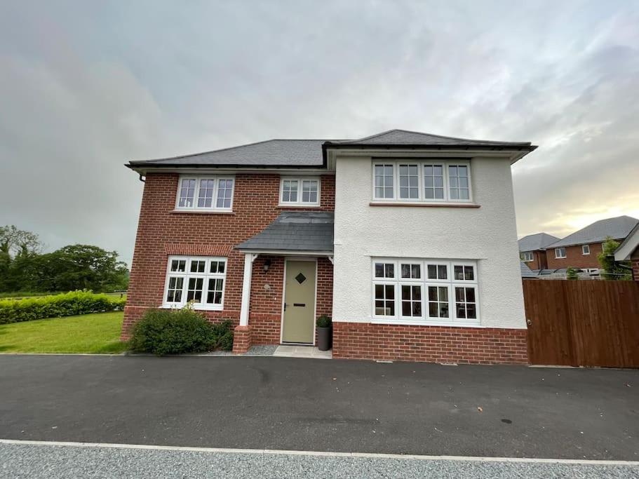 a red brick house with a green door at Snowdonia Retreat in Bangor