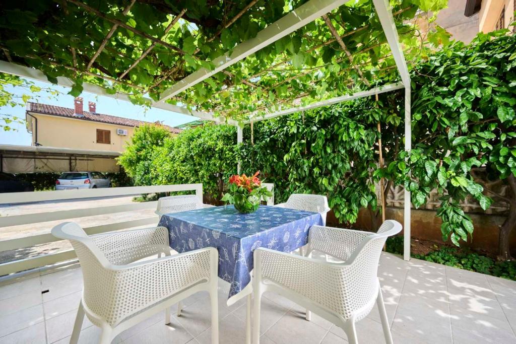 Apartman Ema في نوفيغراد استريا: طاولة وكراسي على فناء مع pergola