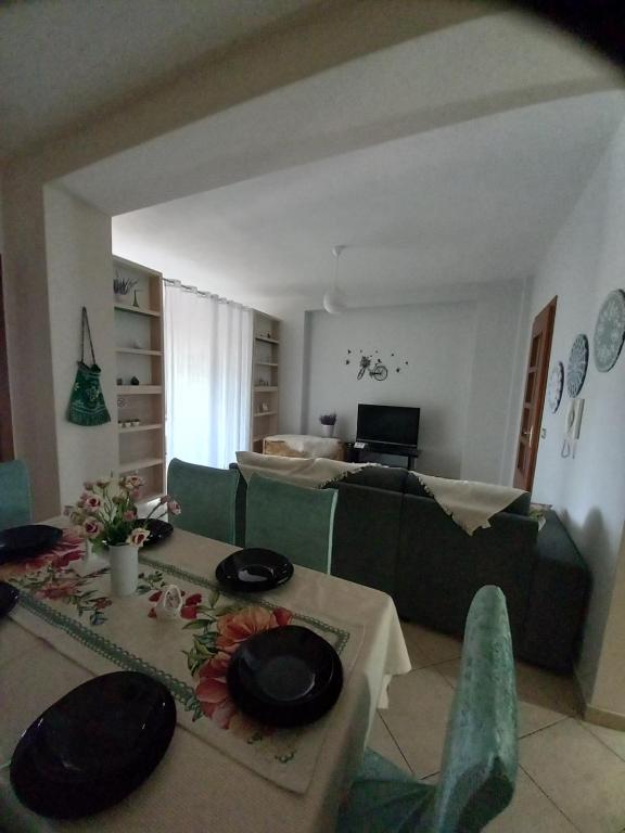 a living room with a couch and a table at Panoramic apartment in Shkodër