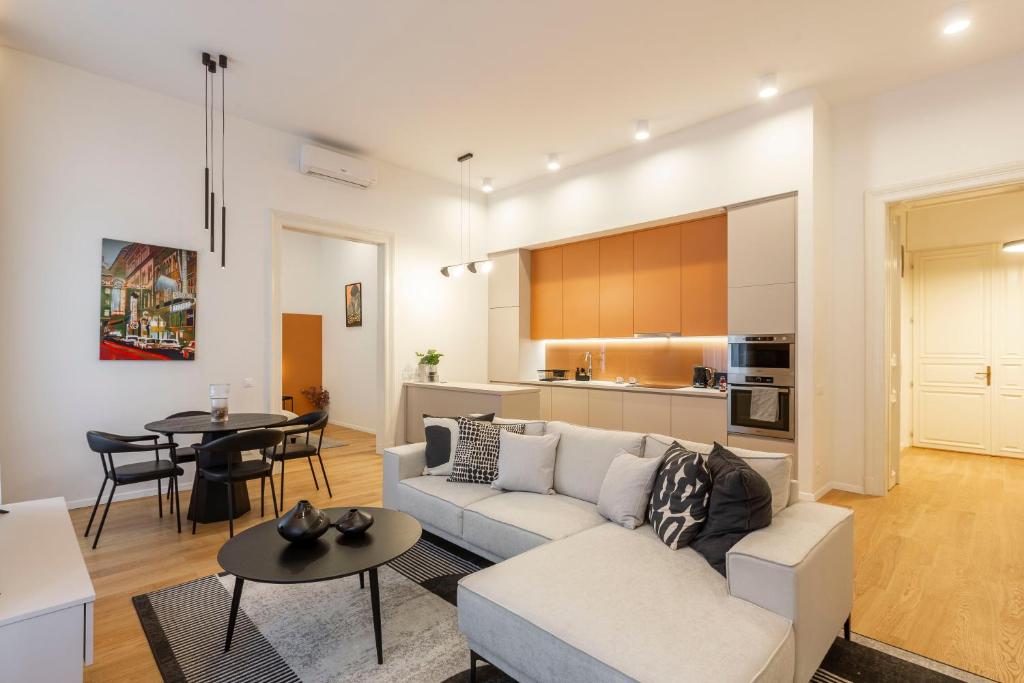 a living room with a couch and a table at Luxurious Minimalist Residence with Sauna by Prestige Homes in Budapest