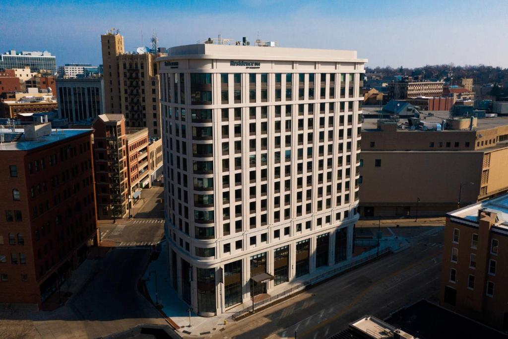 a tall white building in the middle of a city at Residence Inn by Marriott Grand Rapids Downtown in Grand Rapids