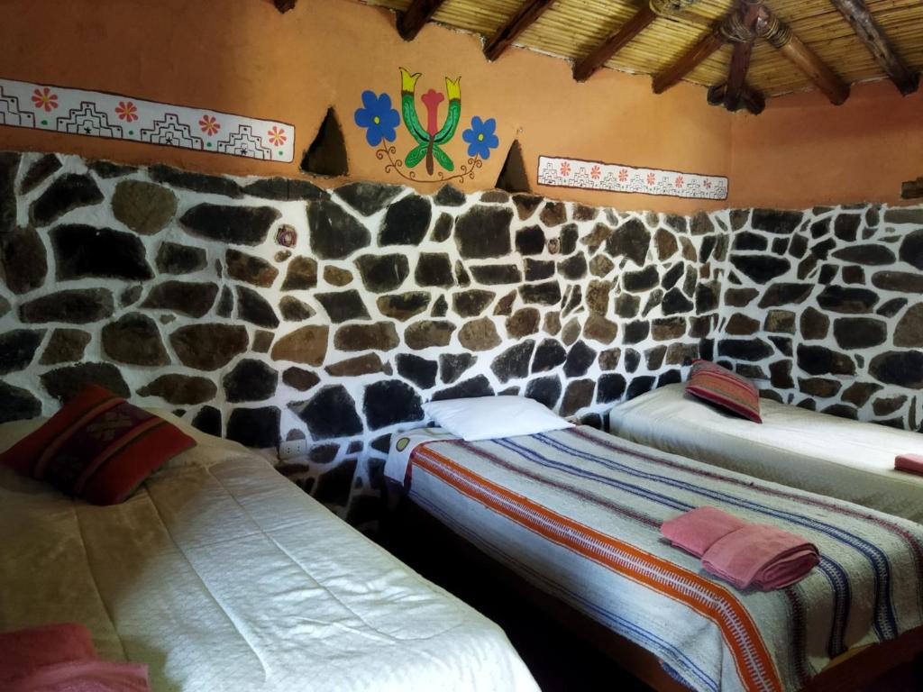 Tempat tidur dalam kamar di Lodge Mirador San Antonio- Colca