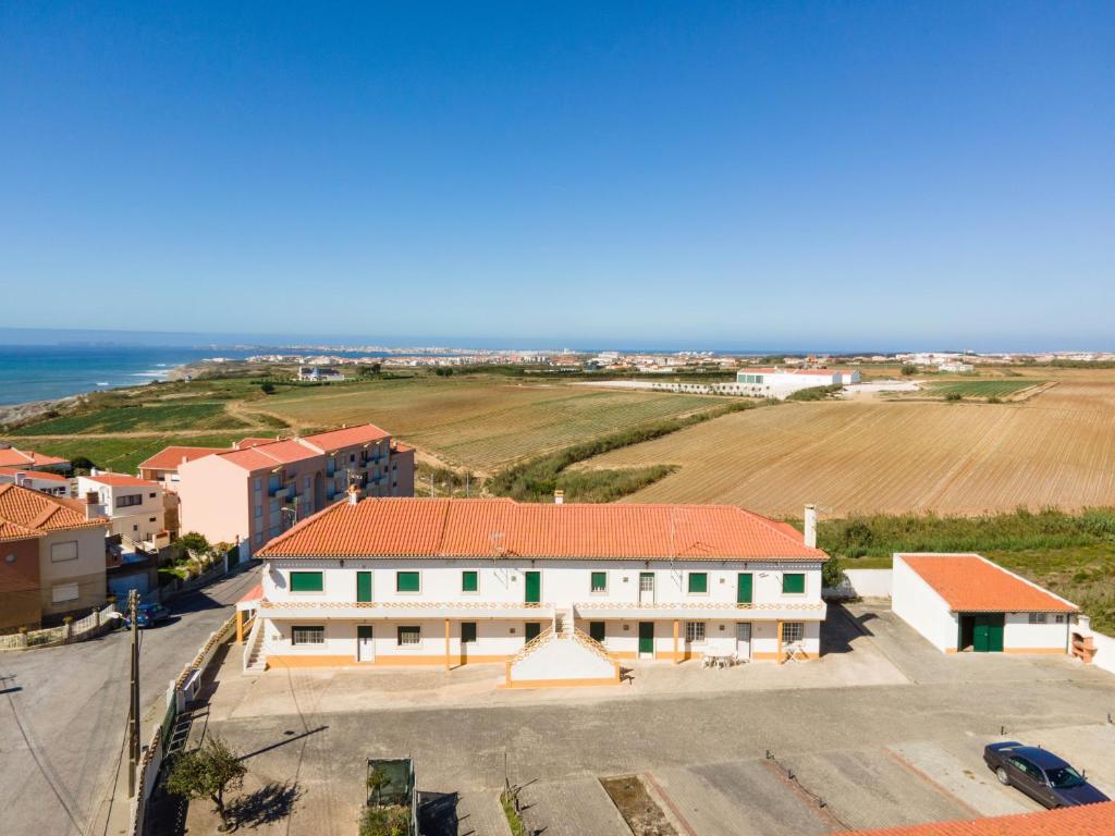 an aerial view of a building and the ocean at Tilli'n'Joe's Beach House in Atouguia da Baleia