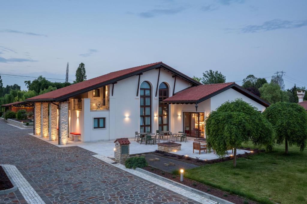 a large white house with a red roof at Il Filo Rosso B&B in Abano Terme