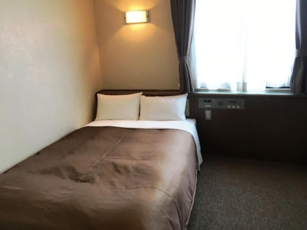 Kuwana Park Hotel - Vacation STAY 66874v में एक कमरे में एक या कई बेड