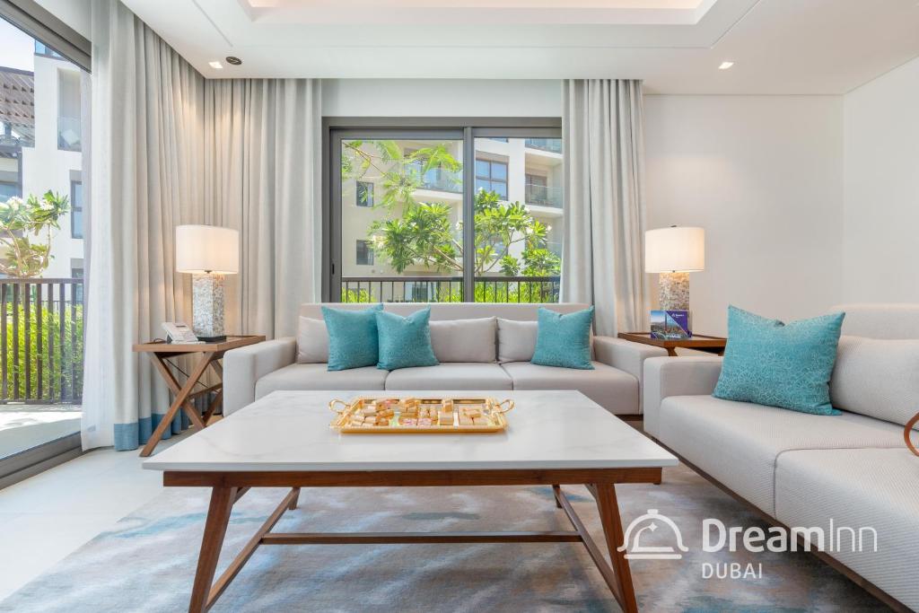 a living room with a couch and a coffee table at Dream Inn - Address Beach Residence Fujairah - Premium Apartments in Fujairah