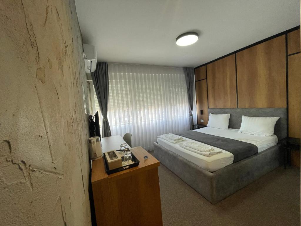 A bed or beds in a room at New Prishtina Luxury Rooms