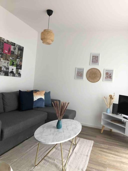 sala de estar con sofá y mesa en Moderne Neue 2 Zimmer Wohnung, en Uetersen