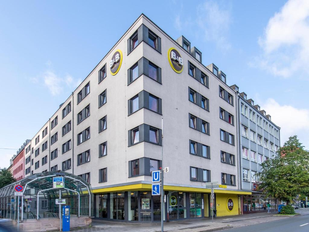 a large white building on a city street at B&B Hotel Nürnberg-City in Nürnberg