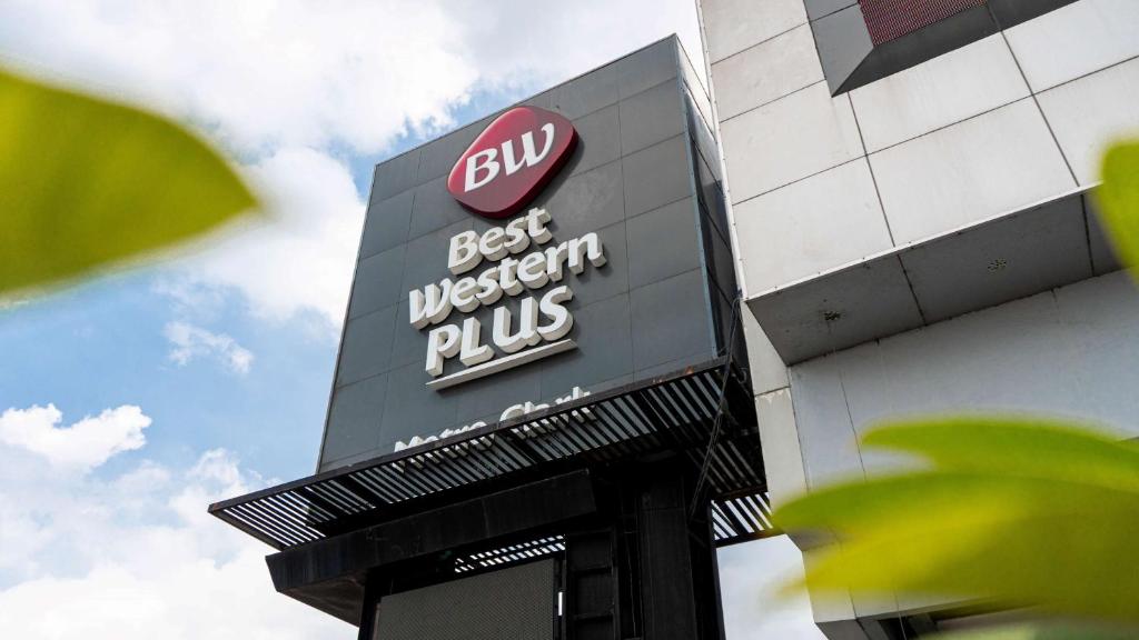 a best western plus sign on the side of a building at Best Western Plus Metro Clark in Angeles