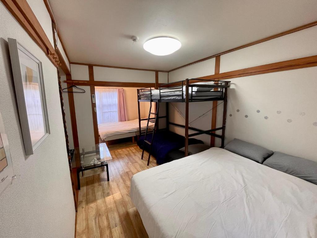 Una cama o camas en una habitación de SunHome コリアタウン近く 一軒家貸切り 今里