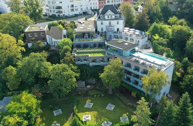 an aerial view of a large building with a yard at Hotel Villa Hügel in Trier