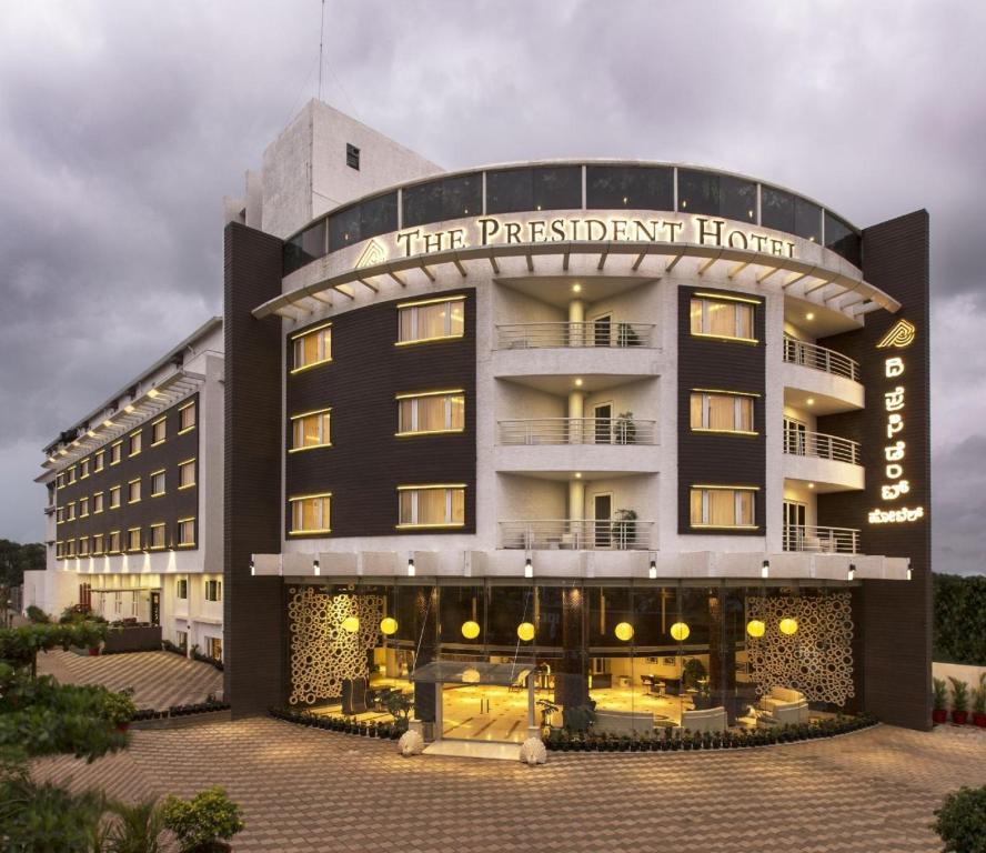 a hotel building with a sign that reads their president hotel at The President Hotel in Hubli