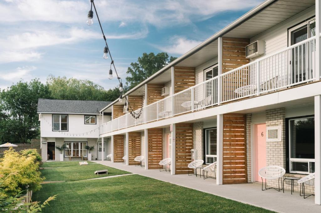 an exterior view of a building with a yard at The June Motel, Prince Edward County in Picton